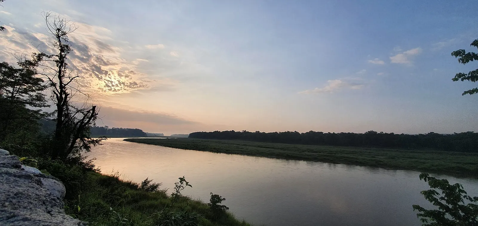 Sunrise light reflecting on the East Rapti river beside Chitwan National Park.