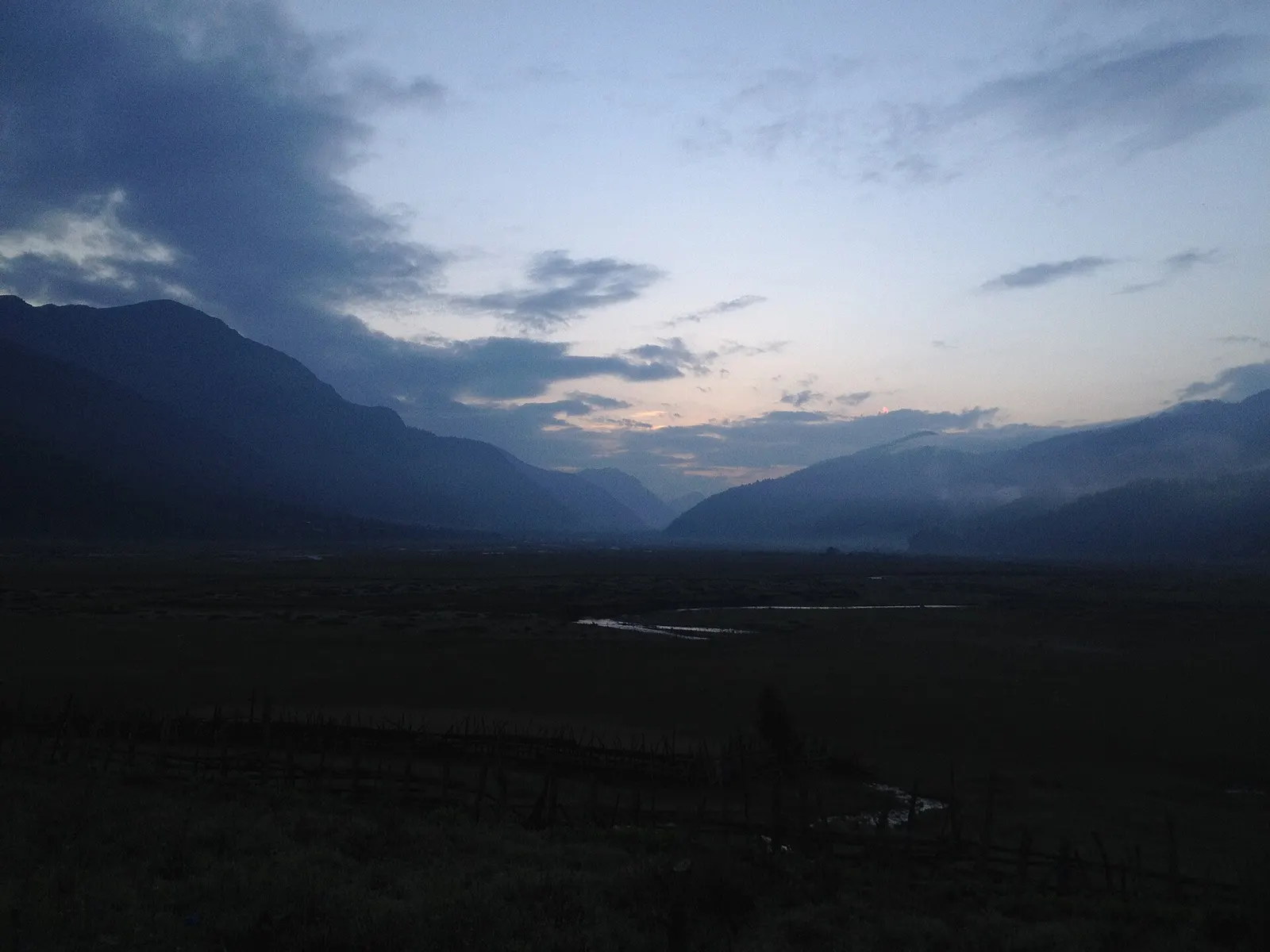 Dark ridges around the Dhorpatan valley silhouetted against the sky before sunrise.