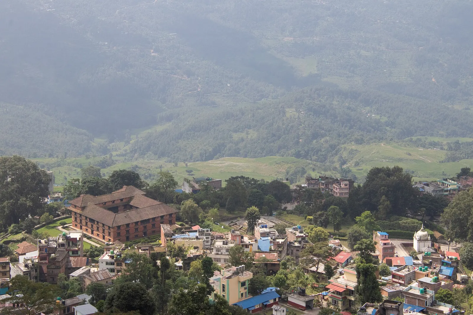 Gorkha town seen from above, with the square Tallo Durbar palace that houses the Gorkha Museum among the houses.