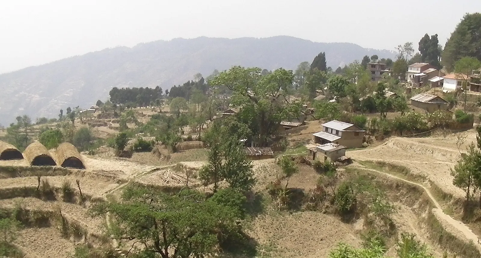 Buildings on the Kakani ridge with hills and Himalayan views beyond.