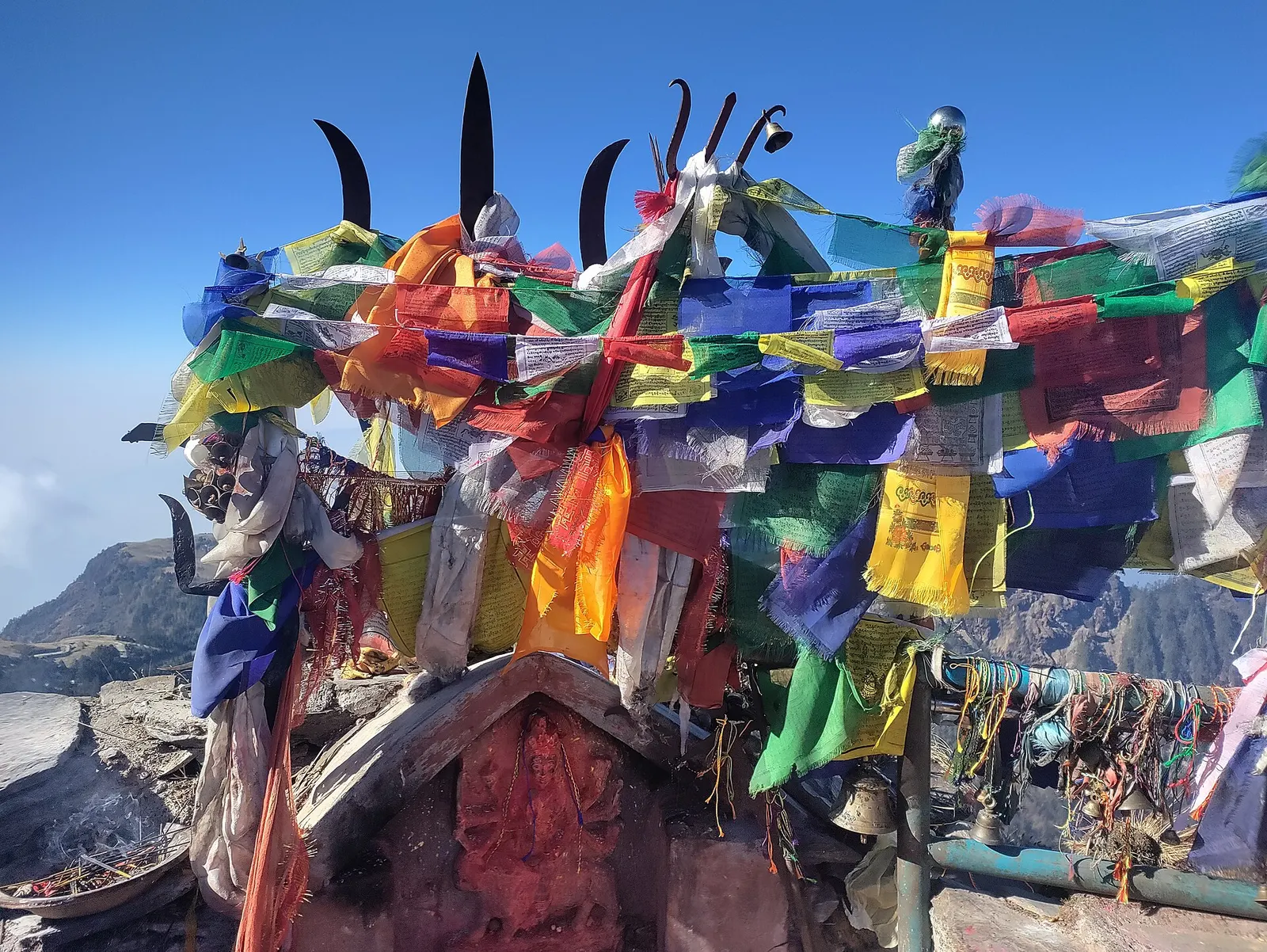 The Kalinchowk Bhagwati shrine area on the open ridge top with bells and prayer flags.