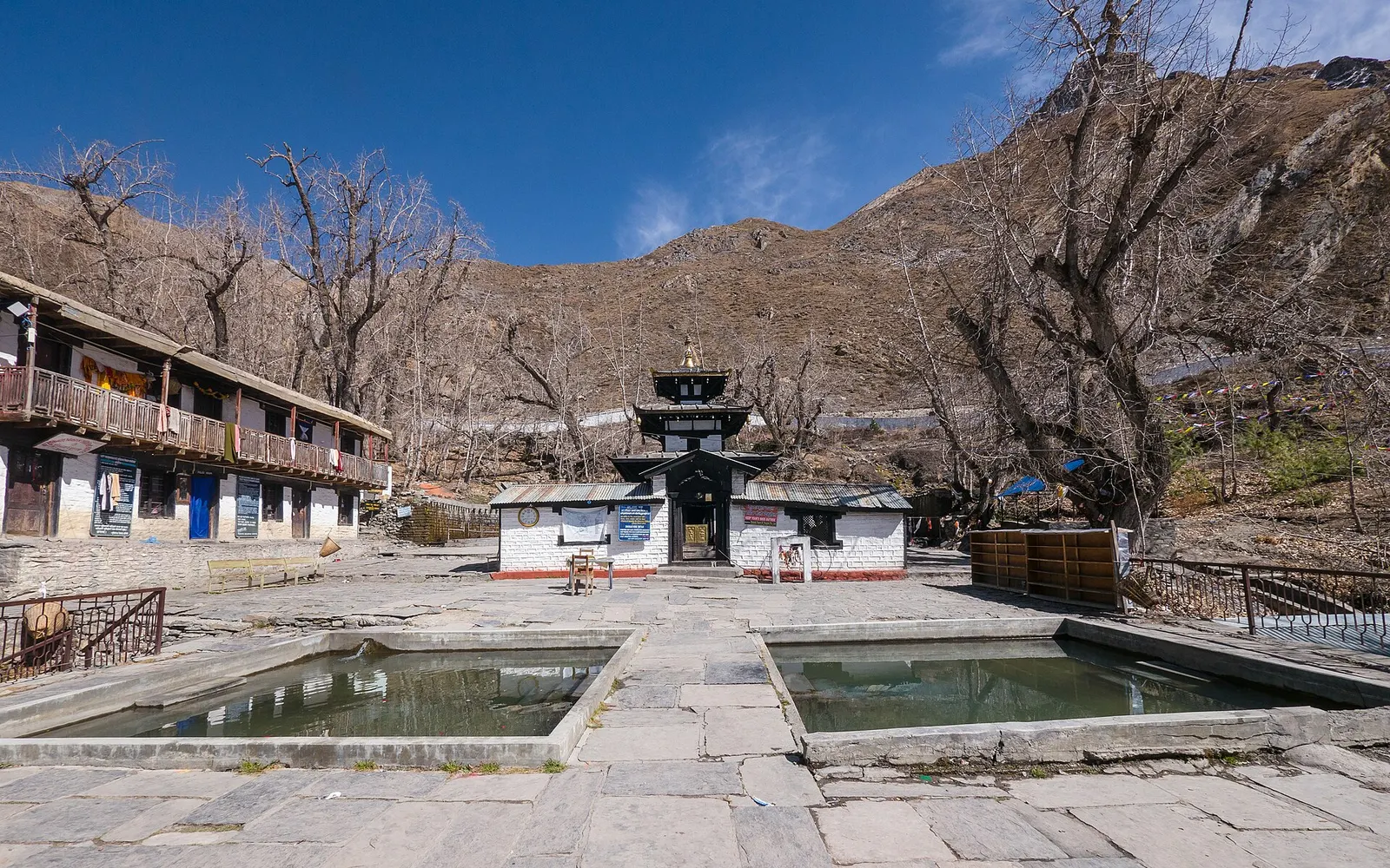 The pagoda-roofed Muktinath temple behind its stone-lined sacred pools.