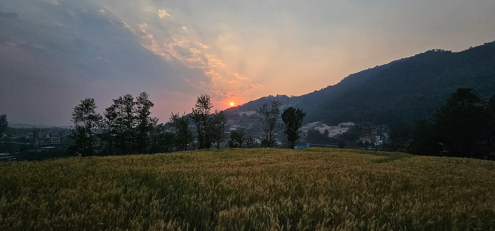 Sunset over forested ridges seen from Shivapuri Nagarjun National Park.