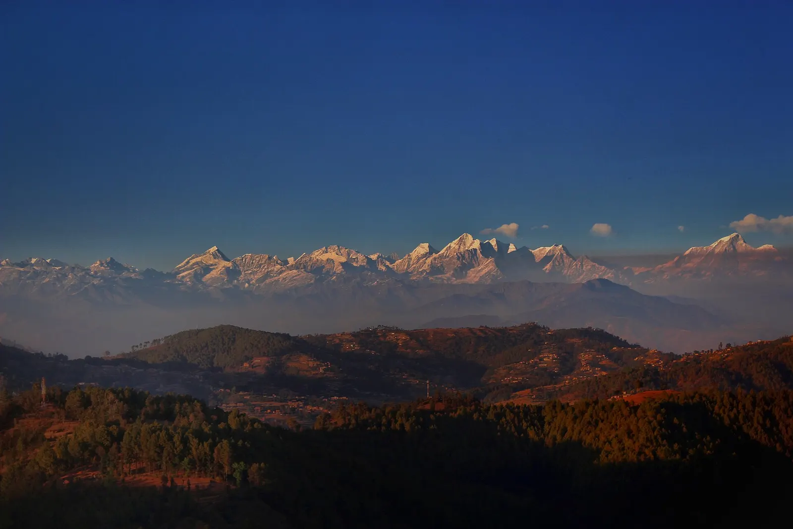 Snow peaks on the northern horizon seen across green hills from Balthali.
